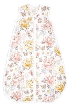 a baby sleeping bag with flowers on the front and side, in white fabric that has pink