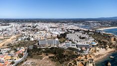 an aerial view of a city and the ocean with buildings on it's sides