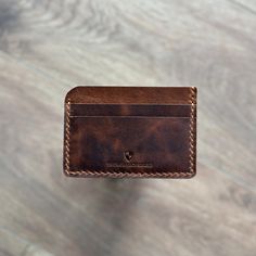 Handcrafted leathercard holder, Minimalist design, Easy to use A slim leather card holder with 5 pockets in total, 2 card slots on each side and one central slip compartment. The Monarch Shield Products are made from full grain leather and is built to last FEATURES 7.5cm x 11cm ✔ 4 card slots ✔ 1 main compartment for cash or more cards ✔ Quality full grain leather ✔ Hand stitched with durable waxed thread - We offer FREE engraving services - Please leave us a note in the personalized box and type your engraving text  - Or at the last page of checkout, below the Submit Order button, there is a box where you can "Add an optional NOTE to the seller." Simply leave your engraving instructions there. If you do miss this step, just send us a message about your engaraving text and we will make it Rectangular Waxed Finish Card Holder Gift, Classic Handmade Card Holder For Daily Use, Brown Leather Patch Card Holder For Everyday, Everyday Brown Leather Patch Card Holder, Brown Card Holder With Interior Slots For Personal Use, Brown Card Holder With Card Slots For Personal Use, Minimalist Brown Card Holder With Coin Pocket, Leather Card Holder With Slots, Minimalist Brown Card Holder With Card Slots