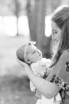 a woman holding a baby in her arms