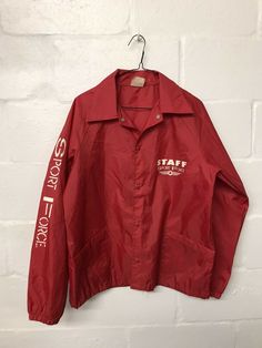 Good condition. Length- 28in. Pit to pit- 22in. Sleeve- 26in. Red Casual Windbreaker For Sports Events, Casual Red Windbreaker For Sports Events, Vintage Long Sleeve Sports Outerwear, Casual Red Track Jacket For Sports Events, Vintage Red Long Sleeve Track Jacket, Vintage Long Sleeve Sport Coat, Vintage Long Sleeve Track Jacket For Sports, Red Casual Windbreaker For College, Casual Red Windbreaker For College