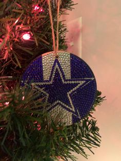 a blue ornament hanging from a christmas tree