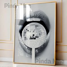 a mirror with a disco ball on it in front of a white wall and floor