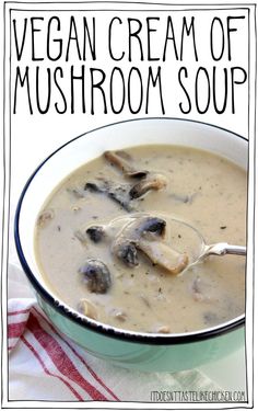 a white bowl filled with mushroom soup on top of a red and white towel