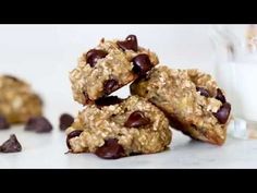 chocolate chip oatmeal cookies stacked on top of each other next to a glass of milk