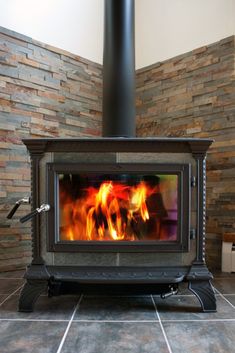 a wood burning stove in a room with tile flooring