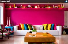 a living room filled with furniture and colorful walls