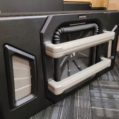 a large speaker sitting on top of a carpeted floor