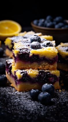 blueberry cheesecake bars stacked on top of each other with fresh blueberries around them