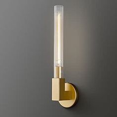 a light that is on the side of a wall with a glass tube attached to it