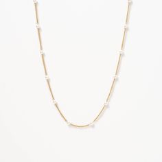 The Satellite Pearl Chain Necklace is a delicate and elegant piece of jewelry that is perfect for any occasion. Featuring a chain adorned with lustrous pearls, it has a minimalist design that exudes sophistication. Wear it alone or layer it with other necklaces to create a unique look that reflects your personal style. Minimalist Pearl Chain Jewelry, Classic White Necklace For Layering, Classic Pearl Necklaces With Delicate Chain, Classic White Chain Necklace With Pearl Charm, Elegant Pearl White Chain Necklace With Delicate Chain, Yellow Gold Pearl Chain Necklace For Layering, Classic Gold-plated Pearl Chain Necklace, Classic Pearl White Necklace With Delicate Chain, Formal Pearl White Chain Necklace With Pearl Chain