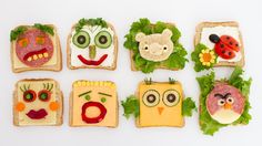 some sandwiches with faces and vegetables on them