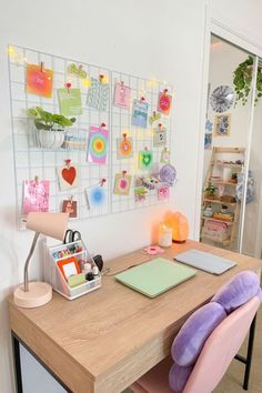 a wooden desk topped with a purple chair next to a wall covered in magnets