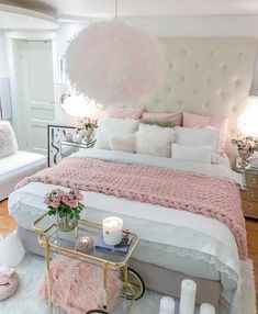 a bedroom with pink and white decor on the walls, flooring and bedding