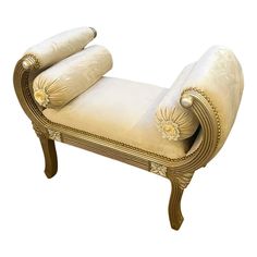 an old fashioned chaise lounge with rolled up pillows on it's back and arms