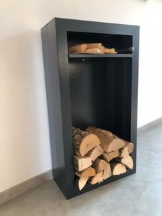 a firewood storage unit is shown with logs in the bottom section and on top shelf