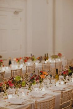 the tables are set with white linens and place settings for dinner guests to sit at