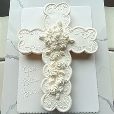 a white card with a cross and roses on the front that says god is born