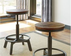 two stools in front of a window with curtains