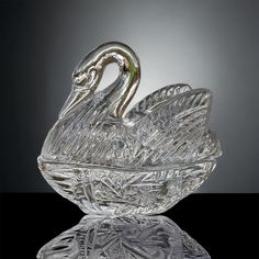 a glass swan sitting on top of a table