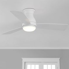 a white ceiling fan mounted on the side of a wall