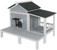 a white dog house with a black roof and door on top of a wooden bench