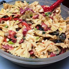 a bowl filled with pasta and vegetables on top of a table