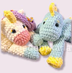 two crocheted stuffed animals sitting next to each other