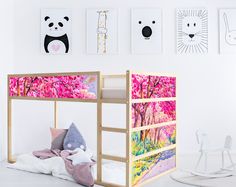 there is a bunk bed with pink flowers on the bottom and panda pictures above it