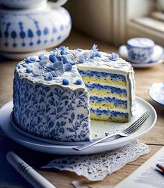 a blue and white cake sitting on top of a plate