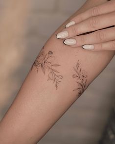 a woman's arm with flowers on it