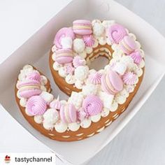 there is a donut decorated with pink and white icing