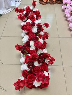 red and white flowers are lined up on the floor