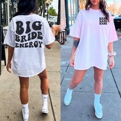 two women walking down the street wearing matching t - shirts and tennis shoes, one in white