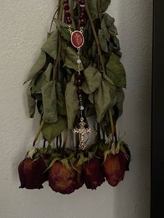 a wall hanging decoration with flowers and beads