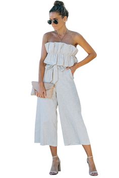 Beige Ruffled Strapless Wide Leg Jumpsuit Summer Off-shoulder Ruffled Jumpsuits And Rompers, Chic Beach Jumpsuits And Rompers With Ruffles, Strapless Ruffled Jumpsuits And Rompers For Spring, Chic Beige Strapless Jumpsuit For Summer, Chic Strapless Jumpsuit For Beach Season, Summer Strapless Ruffled Jumpsuits And Rompers, Beige Strapless Jumpsuit For Summer, Sleeveless Ruffled Jumpsuits And Rompers For Day Out, Chic Strapless Jumpsuit With Ruffles For Spring