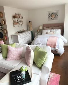 a white couch sitting next to a bed in a bedroom