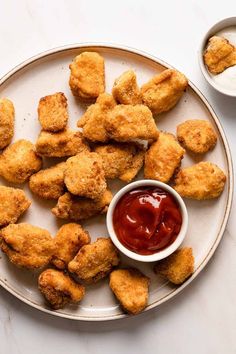 fried chicken nuggets with ketchup on a plate