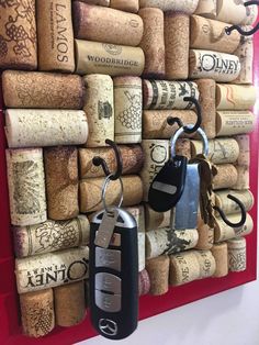 wine corks are arranged on the wall as a key holder