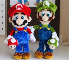 two crocheted mario and luigi amigurt dolls standing next to each other