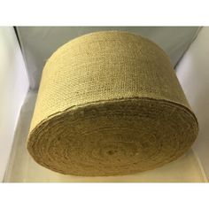 a roll of jute sitting on top of a white counter next to a wall