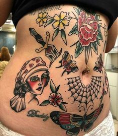 a woman's stomach with tattoos on it