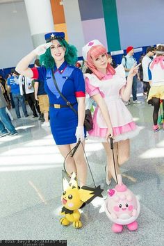 two women dressed as pokemon and pikachu in an airport with people walking around