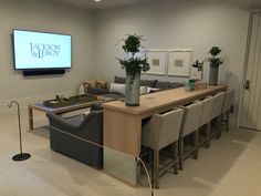 a living room filled with furniture and a flat screen tv mounted to the side of a wall