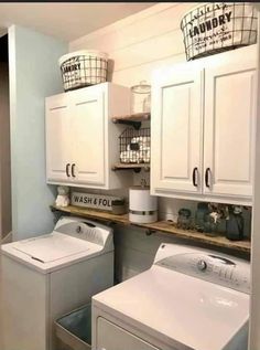 a washer and dryer in a small laundry room with white cabinetry, drawers, and shelves