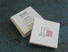 two business cards sitting on top of each other