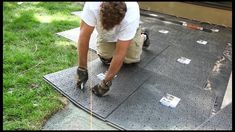 a man in white shirt and khaki pants working on a flat surface with tools