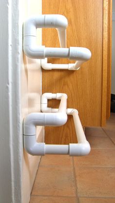 two white pipes are attached to the wall