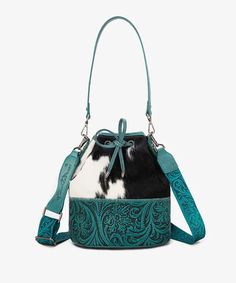 Noted: Due to the natural characteristics of cowhide, each tote bag cow print may vary slightly. The uniqueness of your bag adds to its charm! Genuine hair-on cowhide Floral tooled in hand-coloring on the bottom Drawstring closure on top A detachable printed crossbody strap (Drop: 17"-29") 10.5"(L) x 6"(W) x 10.2"(H) (Hand drop: 10") Montana West Purse, Montana West Handbags, Fanny Pack Purse, Crossbody Phone Purse, Crossbody Saddle Bag, Western Shoes, Western Handbags, Duffle Bag Travel, Intricate Embroidery