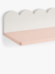 a white shelf with pink shelves on it